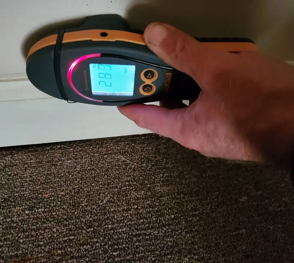 Moisture detection at baseboard during Storm Damage Restoration in Hamilton